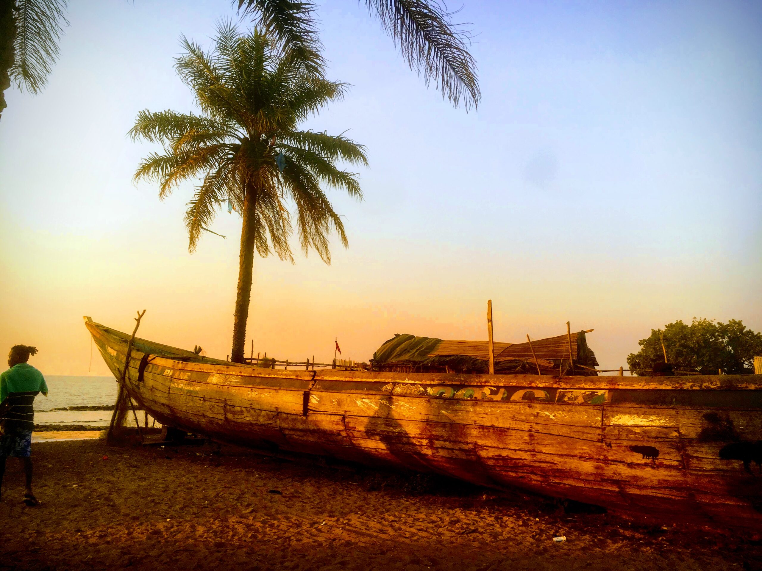 Boat on the beach at sunset