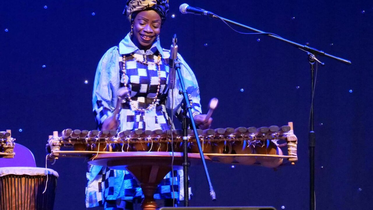 Djeliguinet on stage playing balafon