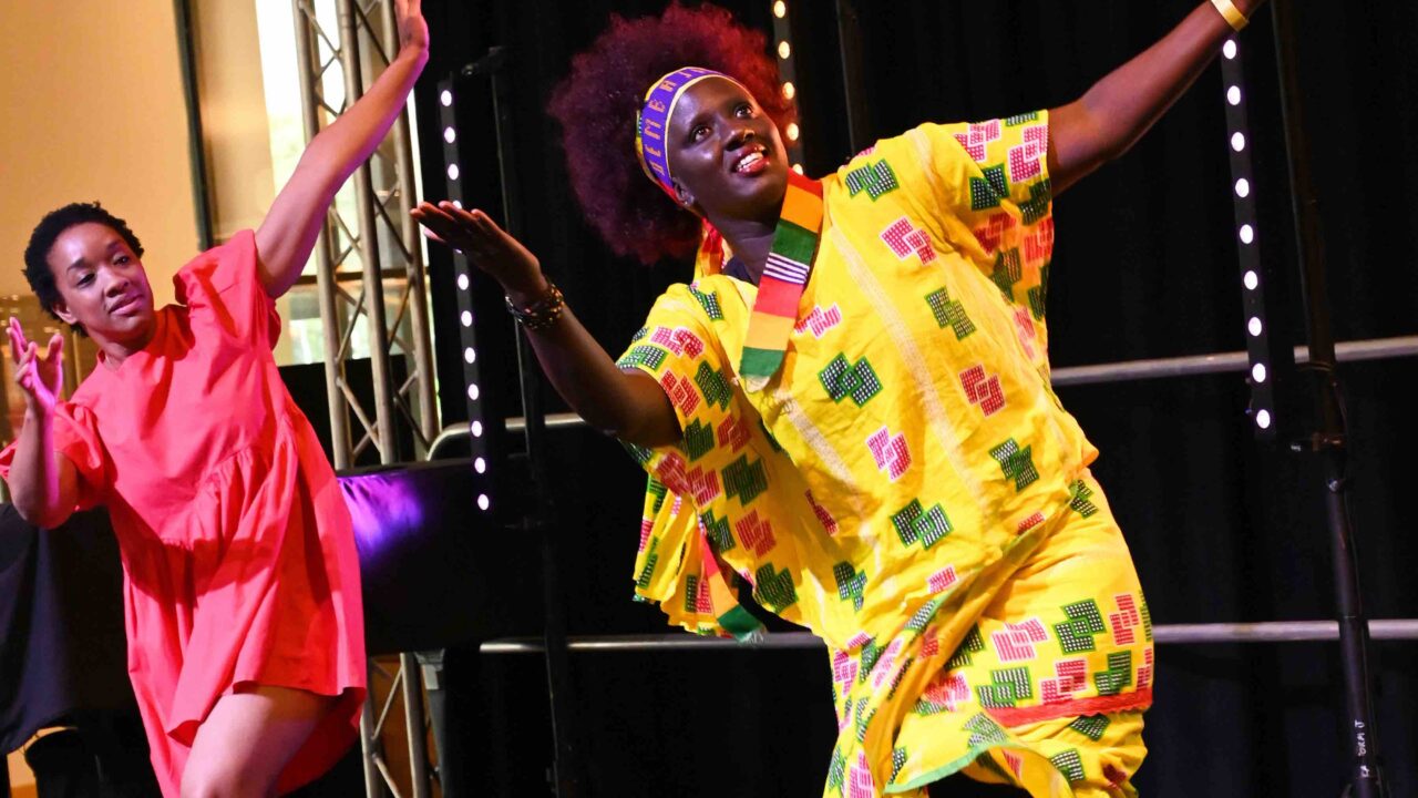 Aida Diop and Krystal Lowe dancing together on the Glanfa Stage at the WMC